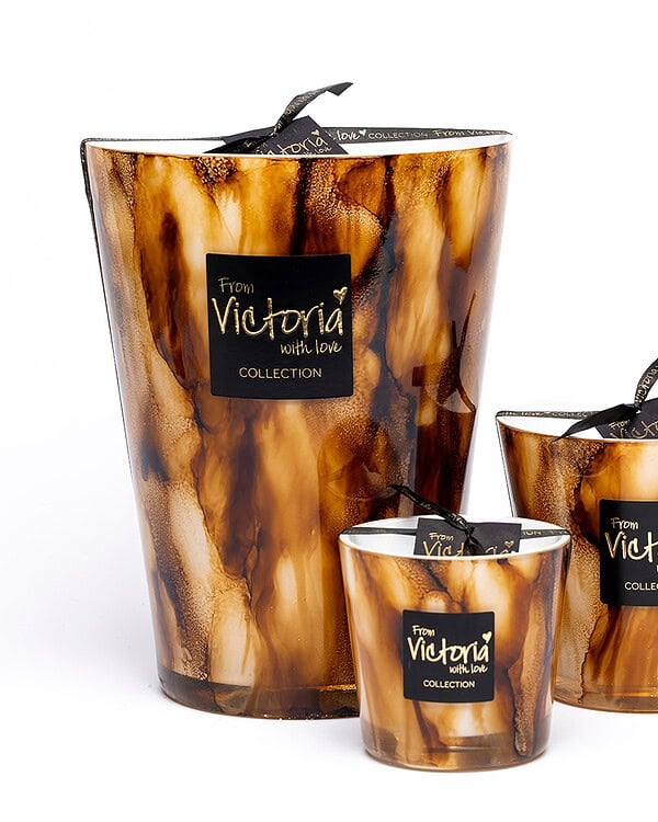 Elegant Victoria With Love candles in marbled holders for home decor.
